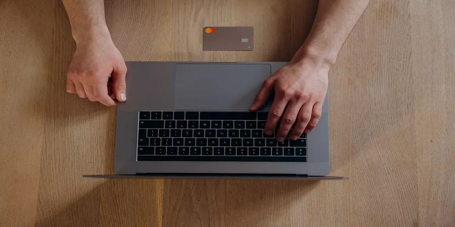 person making a payment on a laptop